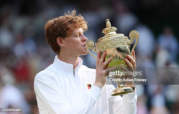 Jannik Sinner of Italy kisses the Gentlemen’s Singles Trophy following his victory against Carlos Alcaraz of Spain during the Gentlemen’s Singles...