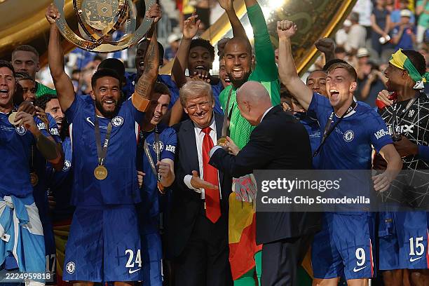President Gianni Infantino directs U.S. President Donald Trump away from the celebrating Chelsea footballers after they won the final match of the...