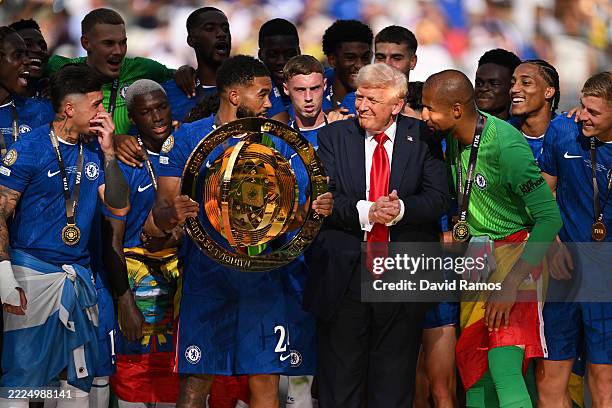 Reece James of Chelsea FC holds the FIFA Club World Cup trophy after their team's victory as U.S. President Donald Trump interacts with Robert...