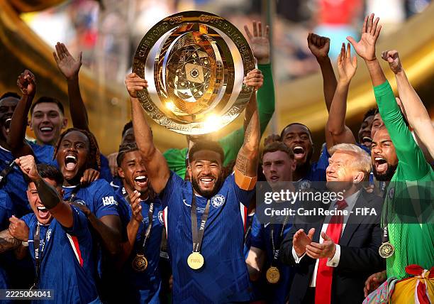 Reece James of Chelsea FC lifts the FIFA Club World Cup trophy after their team's victory as U.S. President Donald Trump reacts following the FIFA...