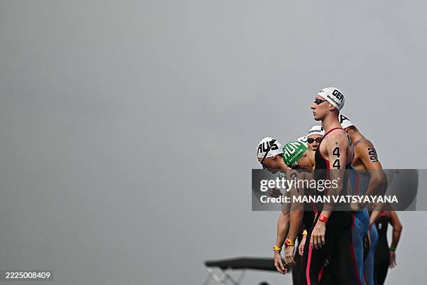 Germany's swimmer Florian Wellbrock and other swimmers prepare to compete in the semi-final of the men's 3km knockout sprint open water swimming...