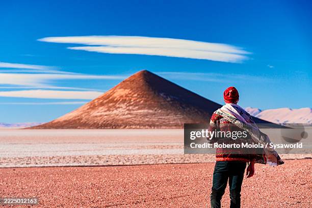 man looking at arita cone volcanic formation - paisaje espectacular fotografías e imágenes de stock