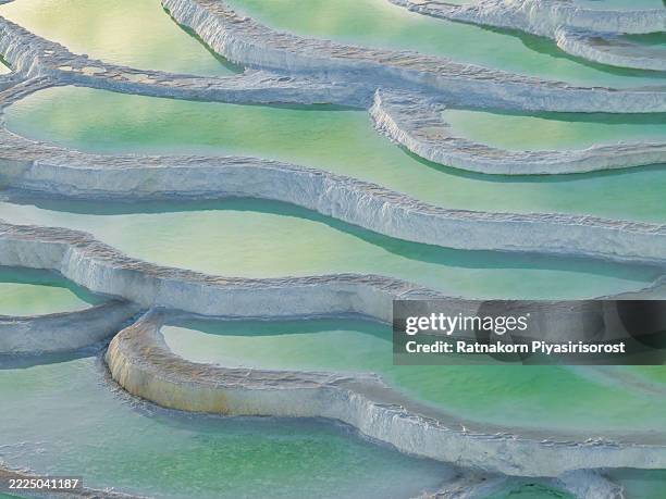 emerald lake, china: terraced green pools form stunning abstract natural patterns. - emerald lake stock pictures, royalty-free photos & images