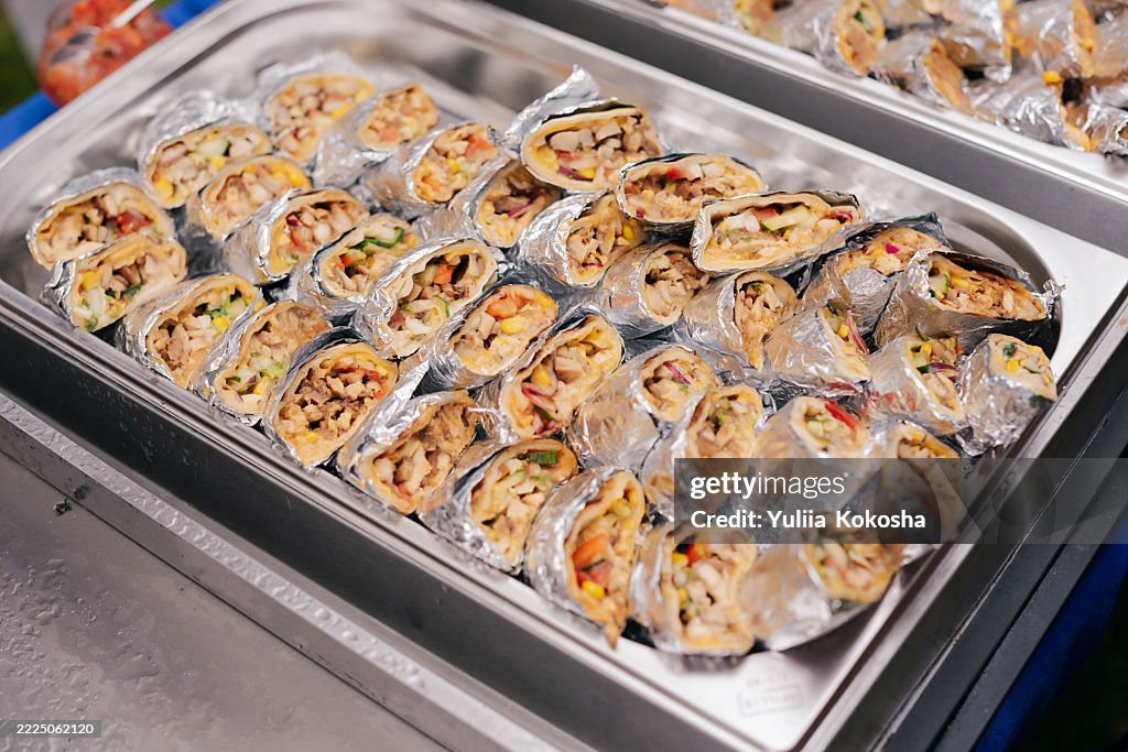 A half-cut grilled chicken wrap at a picnic. Mexican food