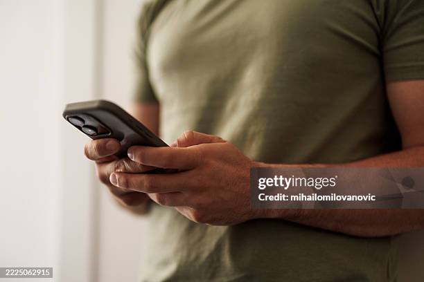 man using smartphone for online messages - scrolling stock pictures, royalty-free photos & images