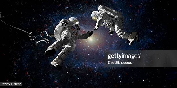 two astronauts about to make contact in space - astronaut bildbanksfoton och bilder