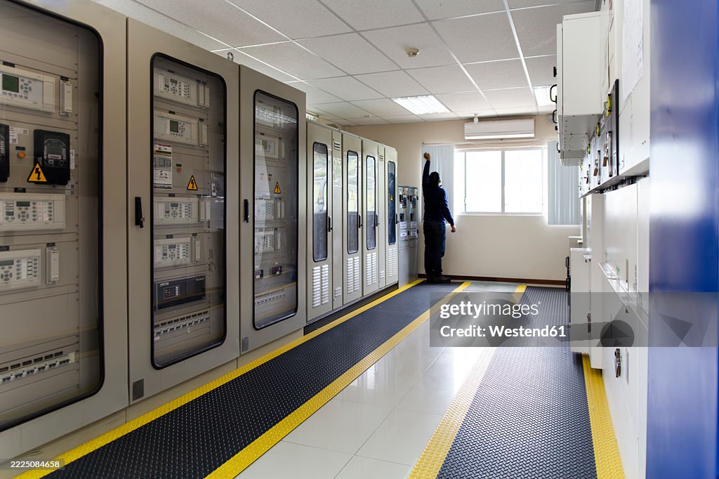 Engineer In A Substation Control Room Monitoring Electrical Systems ...
