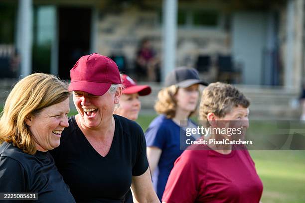 mature women laughing during sports practice - mixed age range stock pictures, royalty-free photos & images