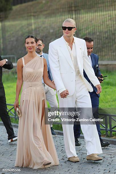 Isabel Haugseng Johansen and Erling Haaland are seen outside the Dolce & Gabbana Alta Moda fashion show at Foro Romano on July 14, 2025 in Rome,...