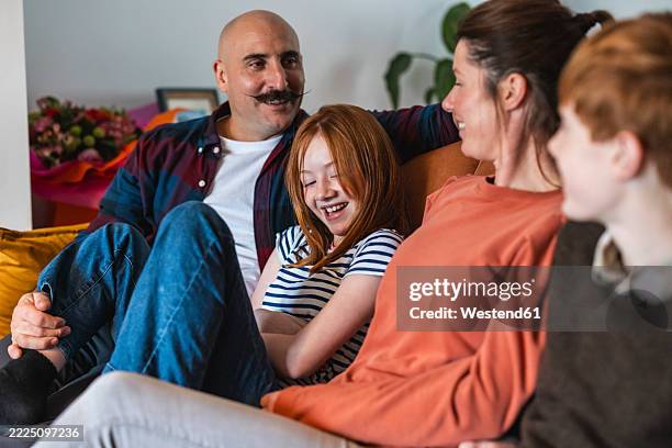 happy family relaxing on the sofa at home - 12 13 years stock pictures, royalty-free photos & images