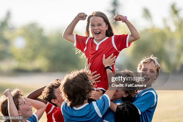 youth soccer team celebrates victory with joyful enthusiasm outdoors - soccer competition stock pictures, royalty-free photos & images