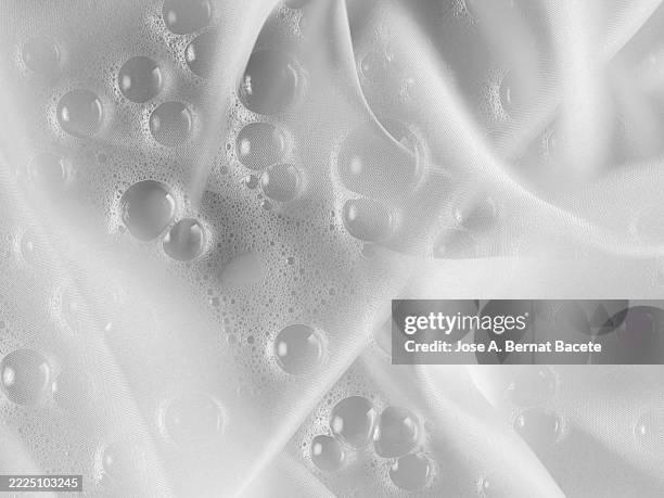 soap suds on a white silk bathrobe. - white foam stock pictures, royalty-free photos & images