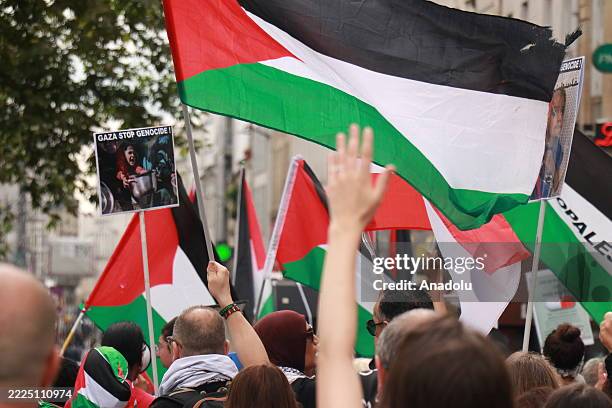 Protesters, holding banners, photos and Palestinian flags, march through central Paris to ongoing Israeli attacks on Gaza, on July 19, 2025 in Paris,...