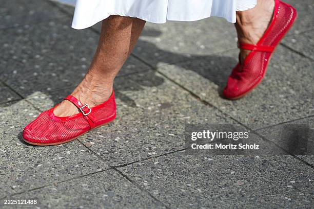 Angelika Hanel is seen wearing a white shirt midi dress with a flared silhouette and soft pleating from Erika Cavallini; a pair of signature Alaïa...