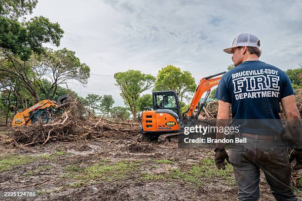 Bruceville-Eddy Fire Department firefighters clear debris during a search and rescue operation on July 14, 2025 in Kerrville, Texas. More than 160...