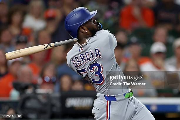 Adolis Garcia of the Texas Rangers hits a home run in the third inning against the Houston Astros at Daikin Park on July 13, 2025 in Houston, Texas.
