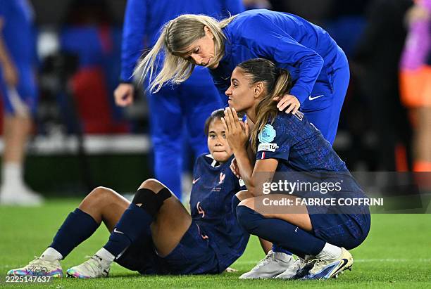 Coaching staff comforts France's defender Alice Sombath and France's defender Maelle Lakrar at the end of the UEFA Women's Euro 2025 quarter finals...