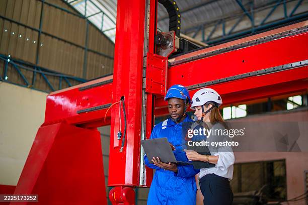 enigineers are working at robot arm factory. - automatic welding torch stock pictures, royalty-free photos & images