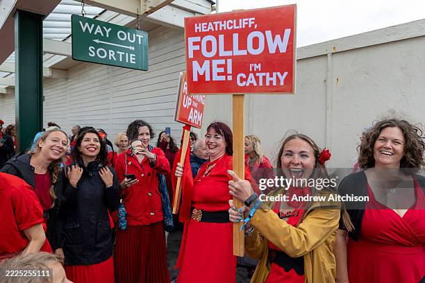 Hundreds of Kate Bush fans came together today wearing red floaty dresses on Folkestone's Harbour Arm to dance to her most iconic song, Wuthering...