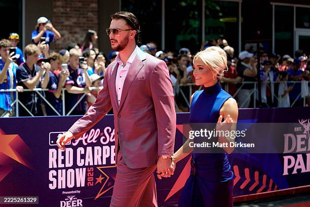 Paul Skenes of the Pittsburgh Pirates walks on the red carpet with his girlfriend Livvy Dunne ahead of the 2025 MLB All-Star Game at Truist Park on...