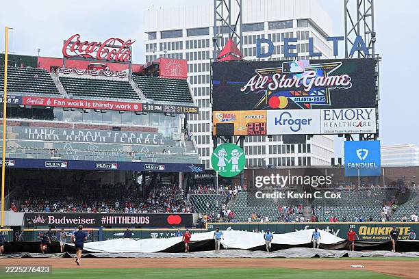 Members of the Atlanta Braves grounds crew spread the tarp onto the field prior to the MLB All-Star Game at Truist Park on July 15, 2025 in Atlanta,...