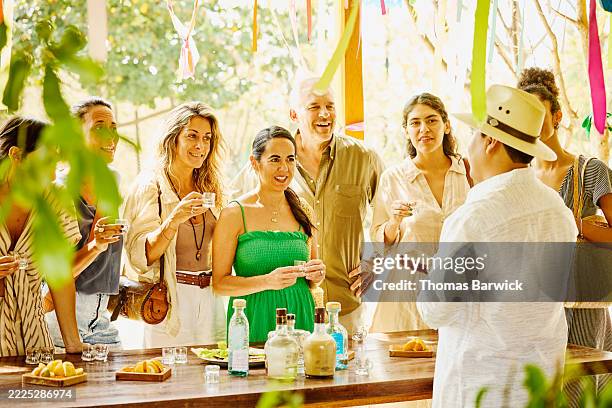medium wide shot tourists listening to distiller talk about mezcal - green hat stock pictures, royalty-free photos & images
