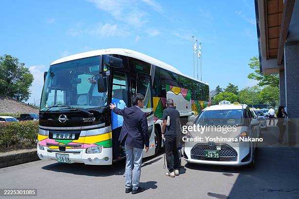 Participants of the Pro-Am are escorted to a bus after its cancellation because a bear was witnessed ahead of MEIJIYASUDA LADIES GOLF TOURNAMENT at...
