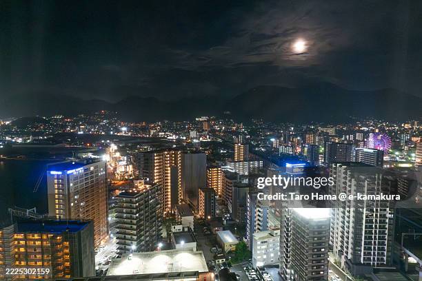 full moon over the residential district by the sea in fukuoka of japan - kitakyushu stock pictures, royalty-free photos & images