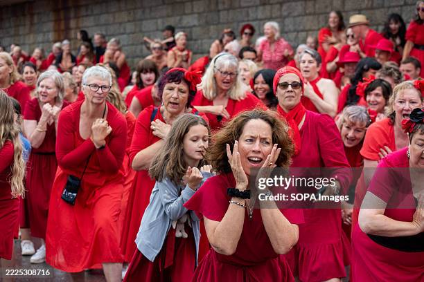Fan follows the choreography during a performance at the Folkestone Pier. Hundreds of Kate Bush fans gathered in red dresses on the Folkestone Pier...