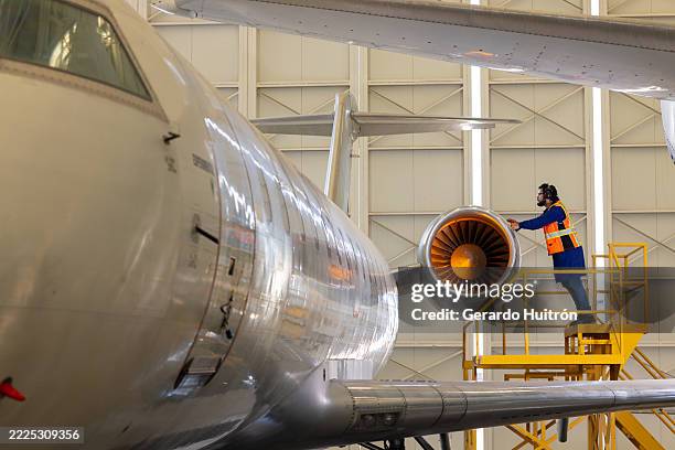 aviation engineer checking one of the engines of a commercial airplane - aeroplane part stock pictures, royalty-free photos & images