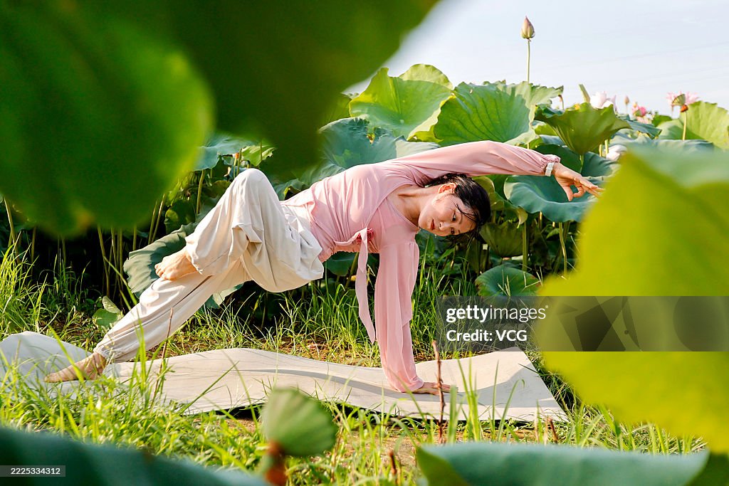 Yoga Enthusiasts Practice Yoga In Lotus Field In Ji'an