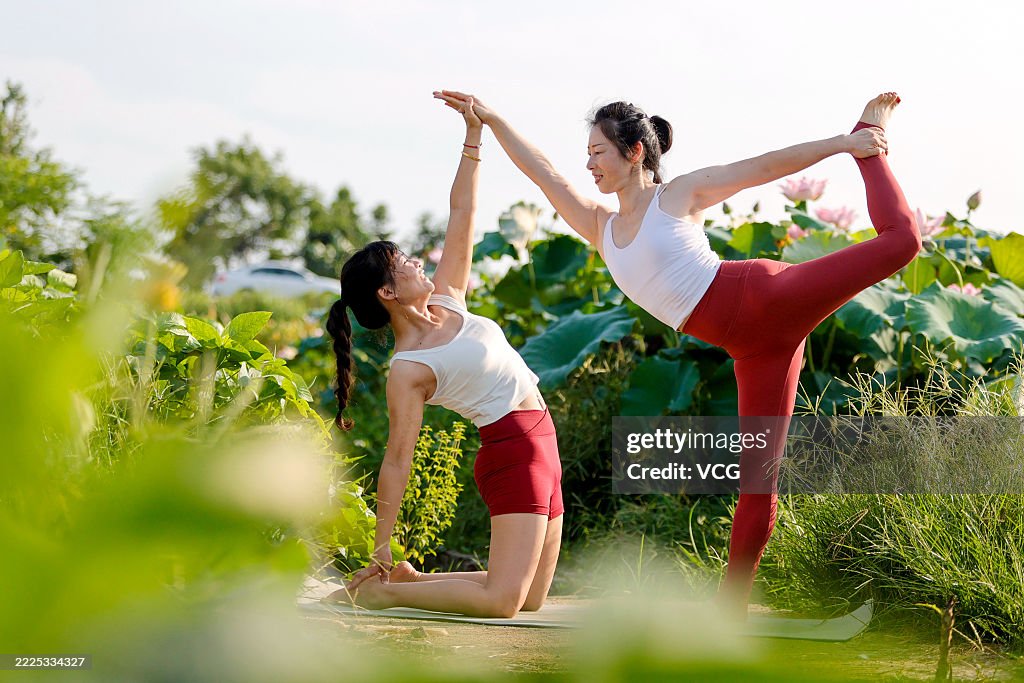 Yoga Enthusiasts Practice Yoga In Lotus Field In Ji'an