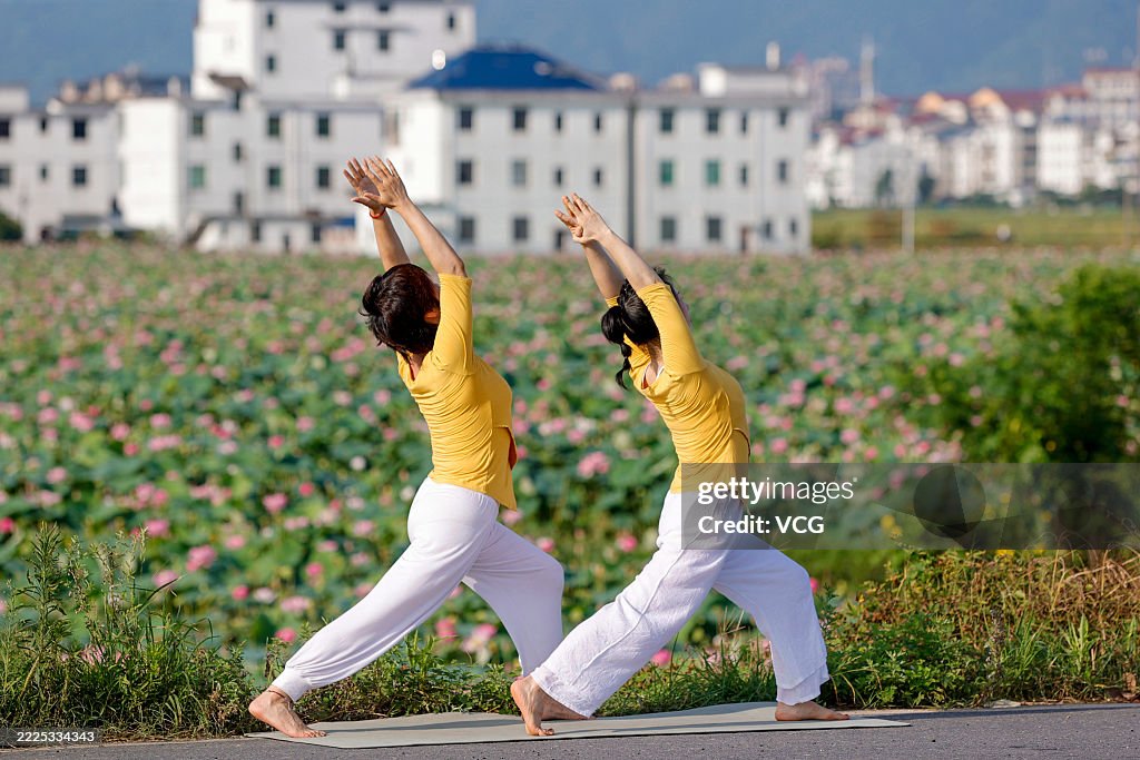 Yoga Enthusiasts Practice Yoga In Lotus Field In Ji'an