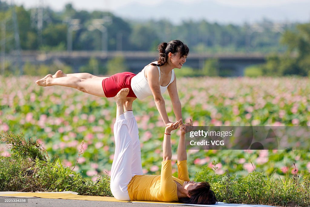 Yoga Enthusiasts Practice Yoga In Lotus Field In Ji'an