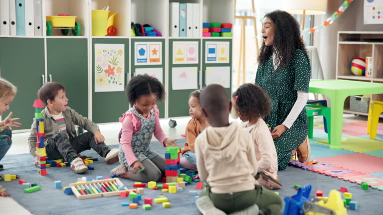 https://media.gettyimages.com/id/2225380505/video/teacher-kids-and-play-with-blocks-in-class-for-learning-problem-solving-and-creative-activity.jpg?b=1&s=640x640&k=20&c=znwg_6OIZTaEAQDd8gGJ2amGtJm0yGLIlYfk4ayZ-lQ=