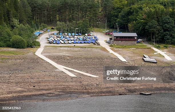 An general view of Errwood reservoir with very low water levels and its near landlocked sailing club on July 16, 2025 in Buxton, England. Errwood...