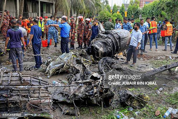 Bangladesh's fire service and security personnel conduct a search and rescue operation after an Air Force training jet crashed into a school in Dhaka...