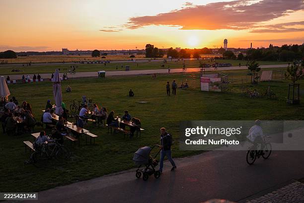 People walk at Tempelhof airfield in Berlin, Germany, on July 16, 2025.