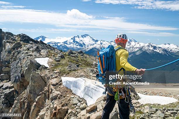 climbing guide leads on rope along mountain ridge - lead concept stock pictures, royalty-free photos & images