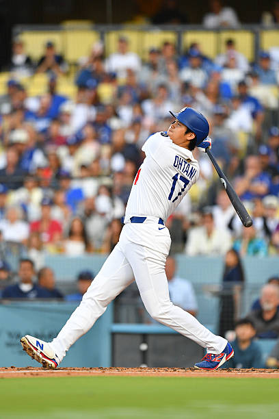 Los Angeles Dodgers designated hitter Shohei Ohtani hits a first inning home run during the MLB game between the Minnesota Twins and the Los Angeles...