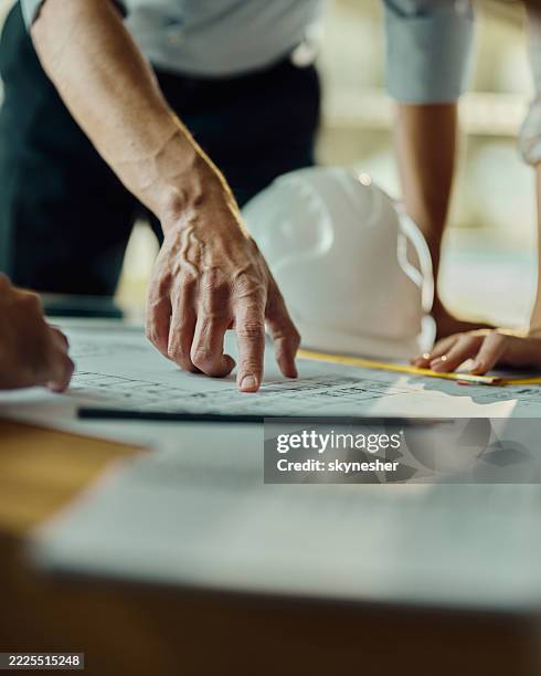 analyzing blueprints on a meeting! - blauwdruk stockfoto's en -beelden