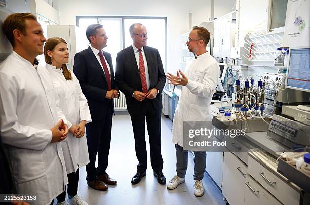 Federal Chancellor Friedrich Merz and Lower Saxony's Minister-President Olaf Lies stand in a laboratory at the Hannover Medical School on July 22,...