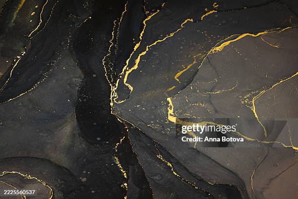 Abstarct fluid ink background with black and golden splashes