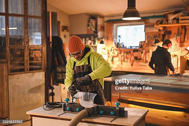 carpenter pouring glue into woodworking machine in workshop - creative space stock pictures, royalty-free photos & images