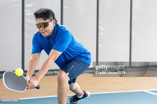eyes on the ball: pickleball in motion - racket sport stock pictures, royalty-free photos & images