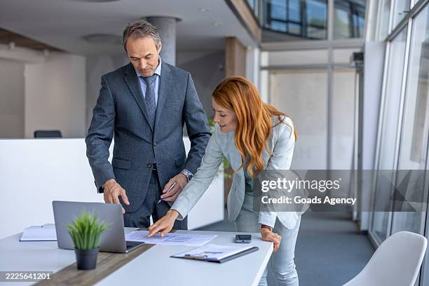 business colleagues analyzing financial reports in modern office - financial report stock pictures, royalty-free photos & images