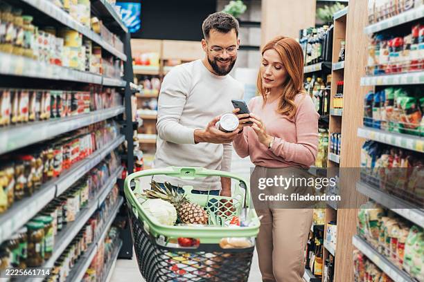 couple shopping in supermarket. - buy online pick up in store stock pictures, royalty-free photos & images