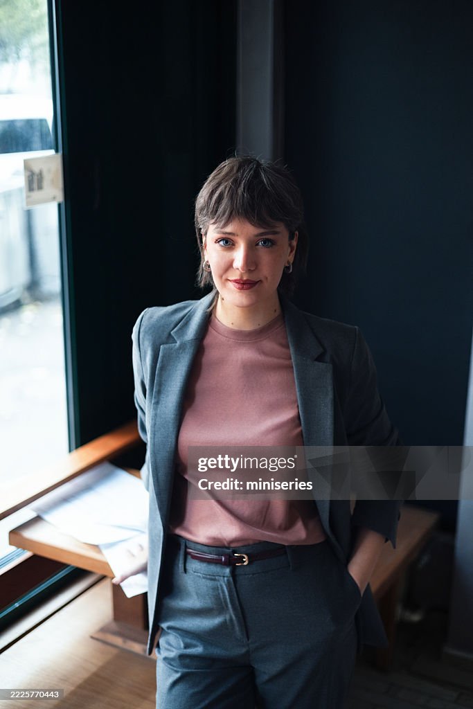 Confident Businesswoman in Modern Attire Posing in Professional Office Environment