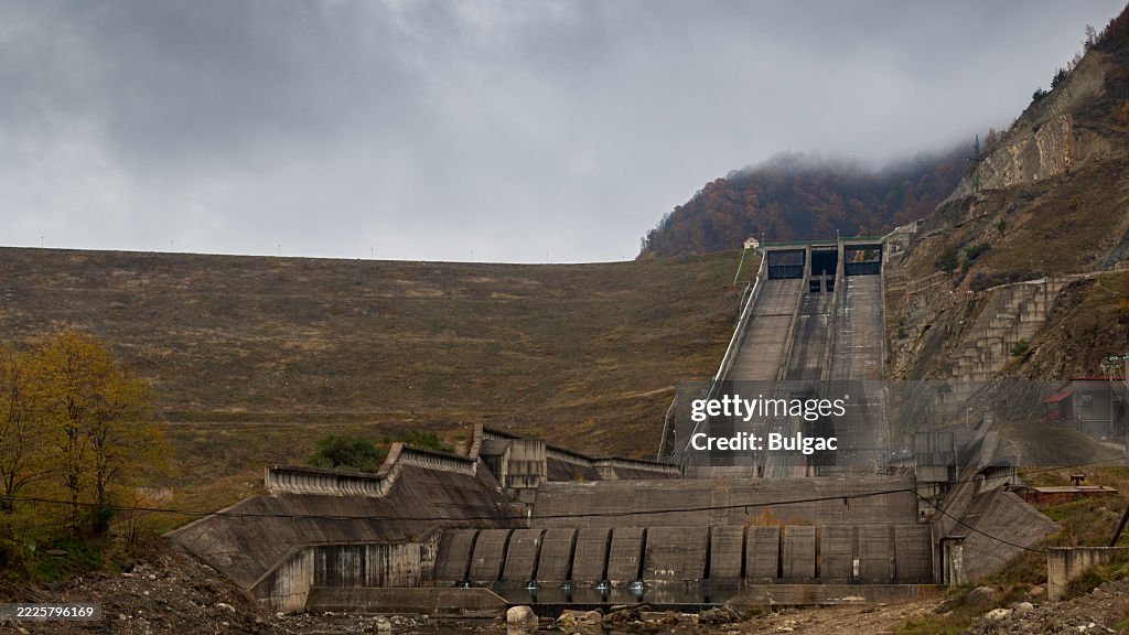Scenic View of a Large Concrete Dam Under a Cloudy Sky