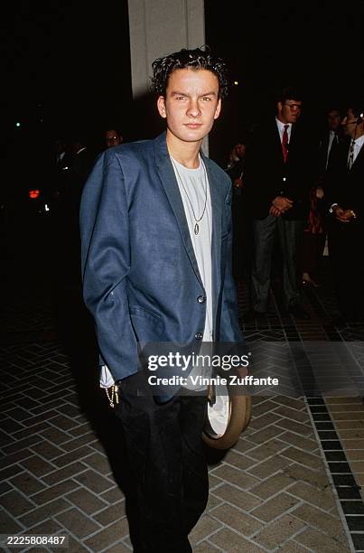 American actor Balthazar Getty, wearing a blue blazer over a white t-shirt with black trousers, holding a brown fedora, attends an 'Entertainment...